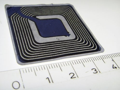 An RFID chip measured against a ruler; one of these can be thrown into a baggage tag  (Source:  WikiMedia Commons)
