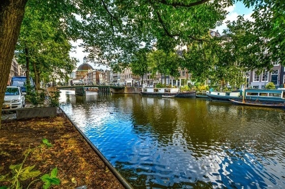 Imagine this canal in Amsterdam, with a number of boats acting as an improvised bridge in times of high traffic.
